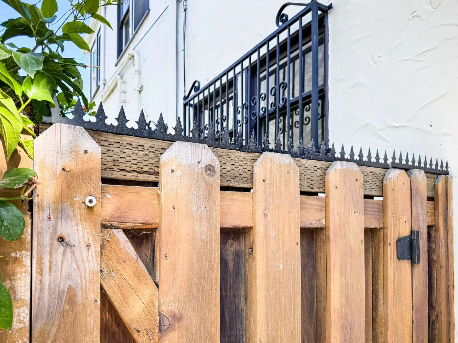 Close-up of the gate`s top edge. Details of the anti-climb spikes and hinges.