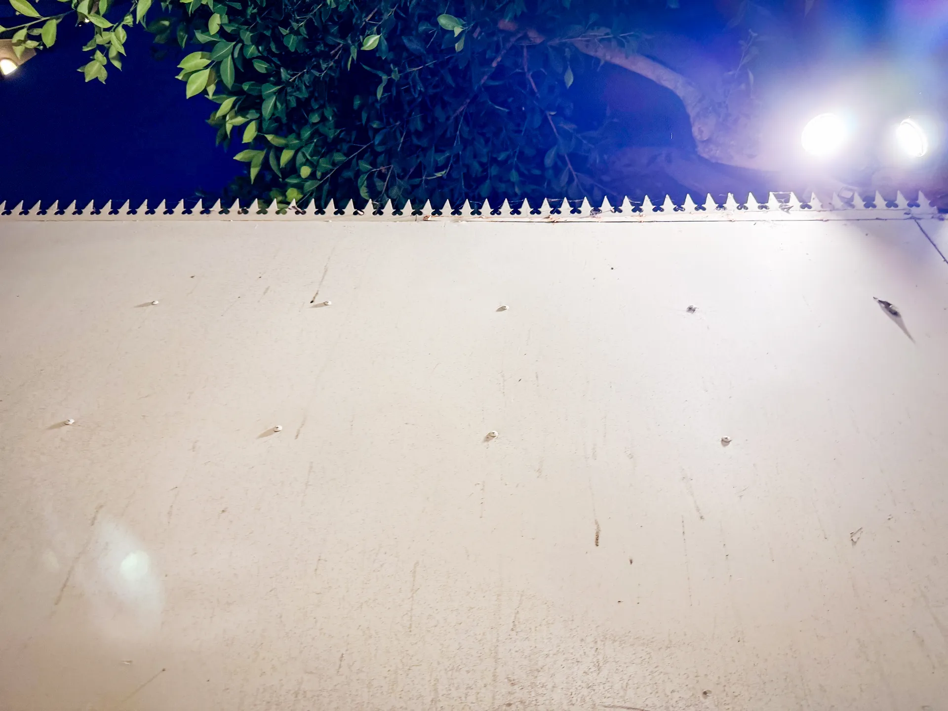 Evening view along the white wall with the spiked crest catching the light