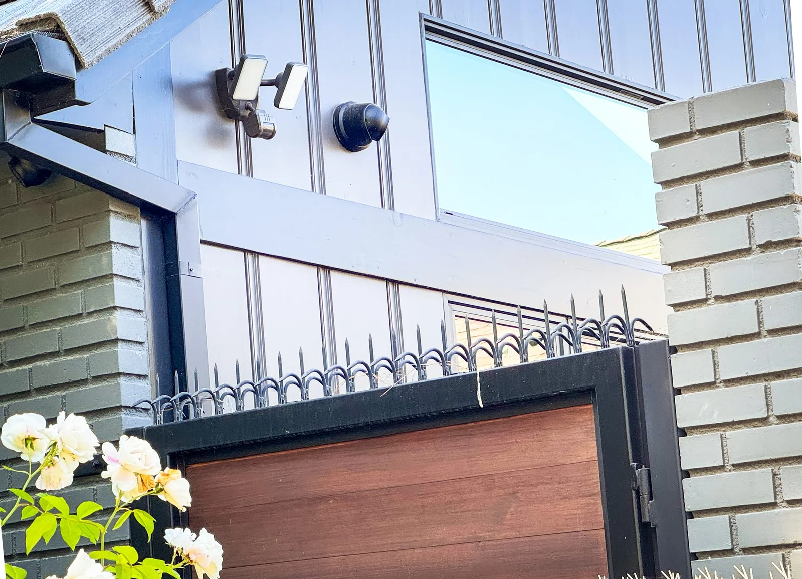 Modern wood and metal front gate in Westwood with anti-climb deterrent installed along the top edge.