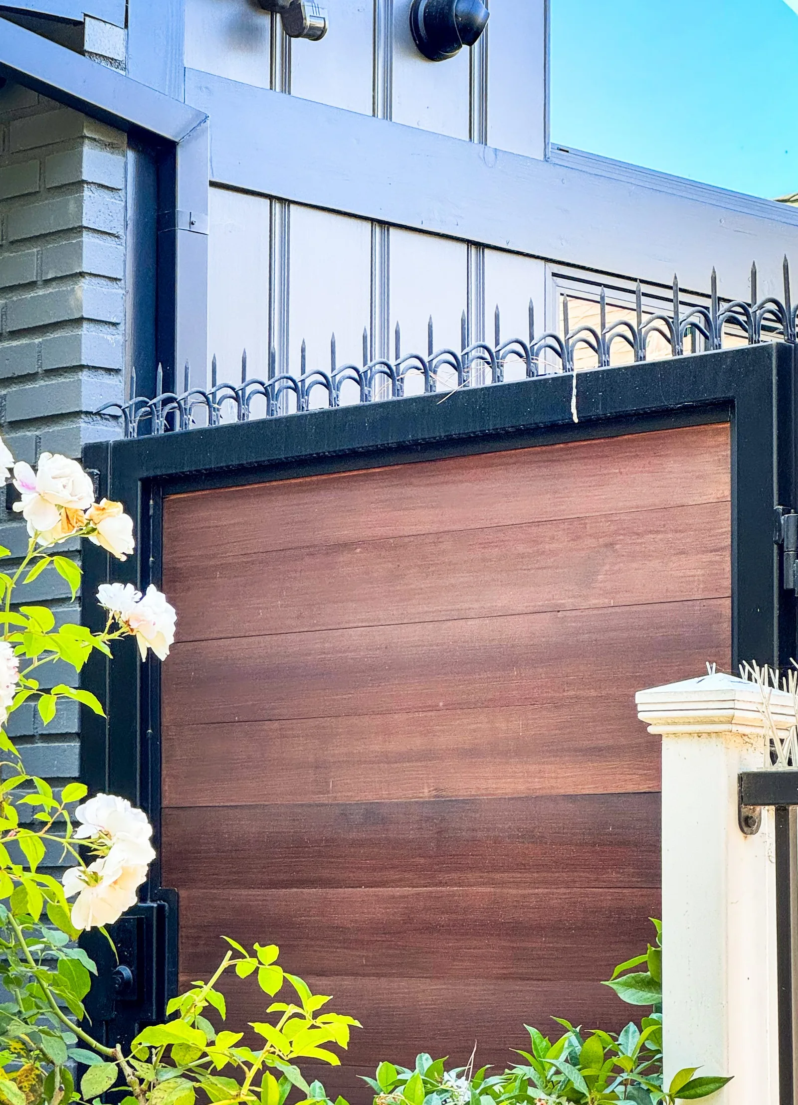 Detail of a black metal gate topline with anti-climb spikes installed, Westwood residential property.