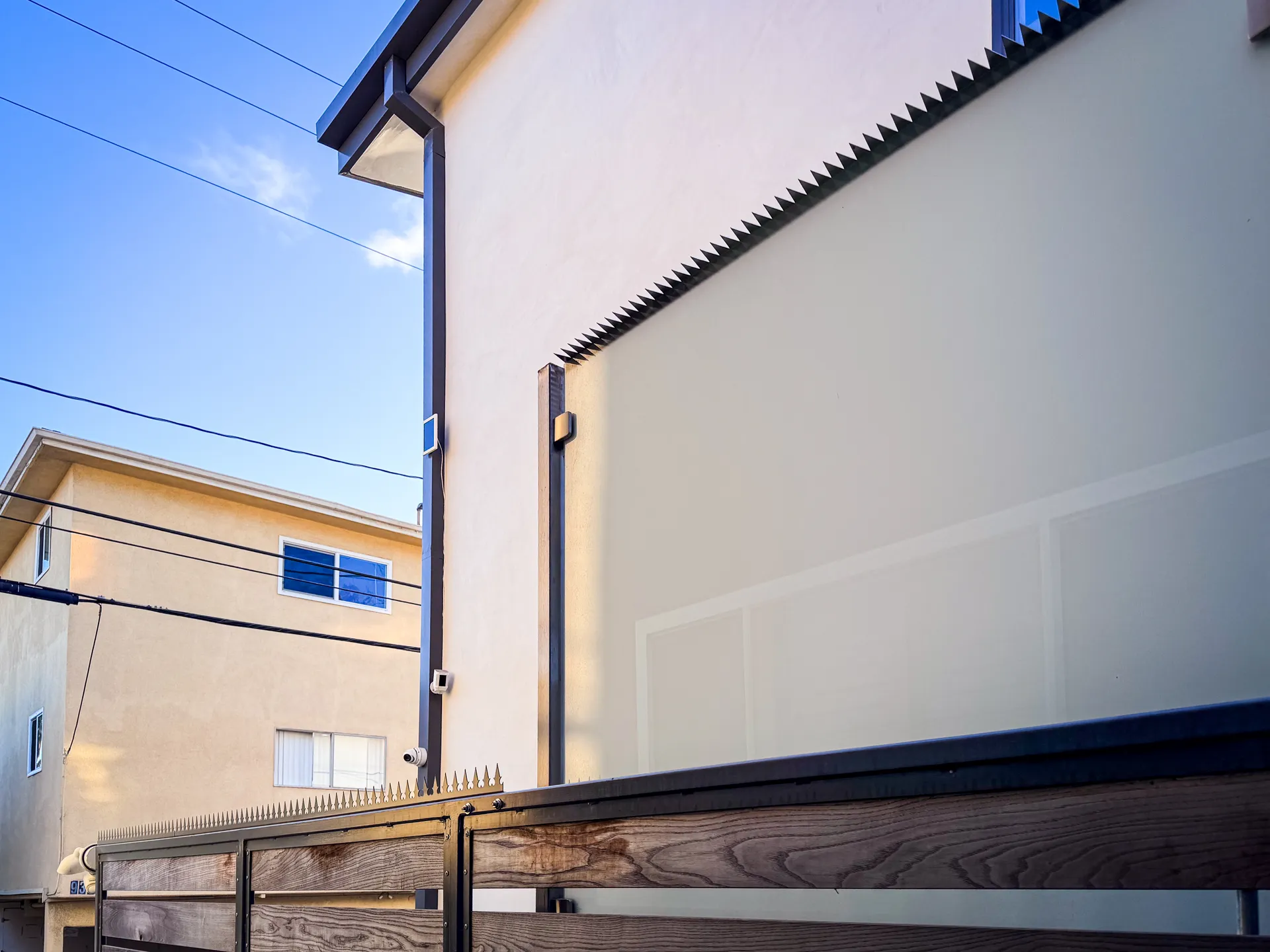 Street-level view of the fence line running along the building perimeter