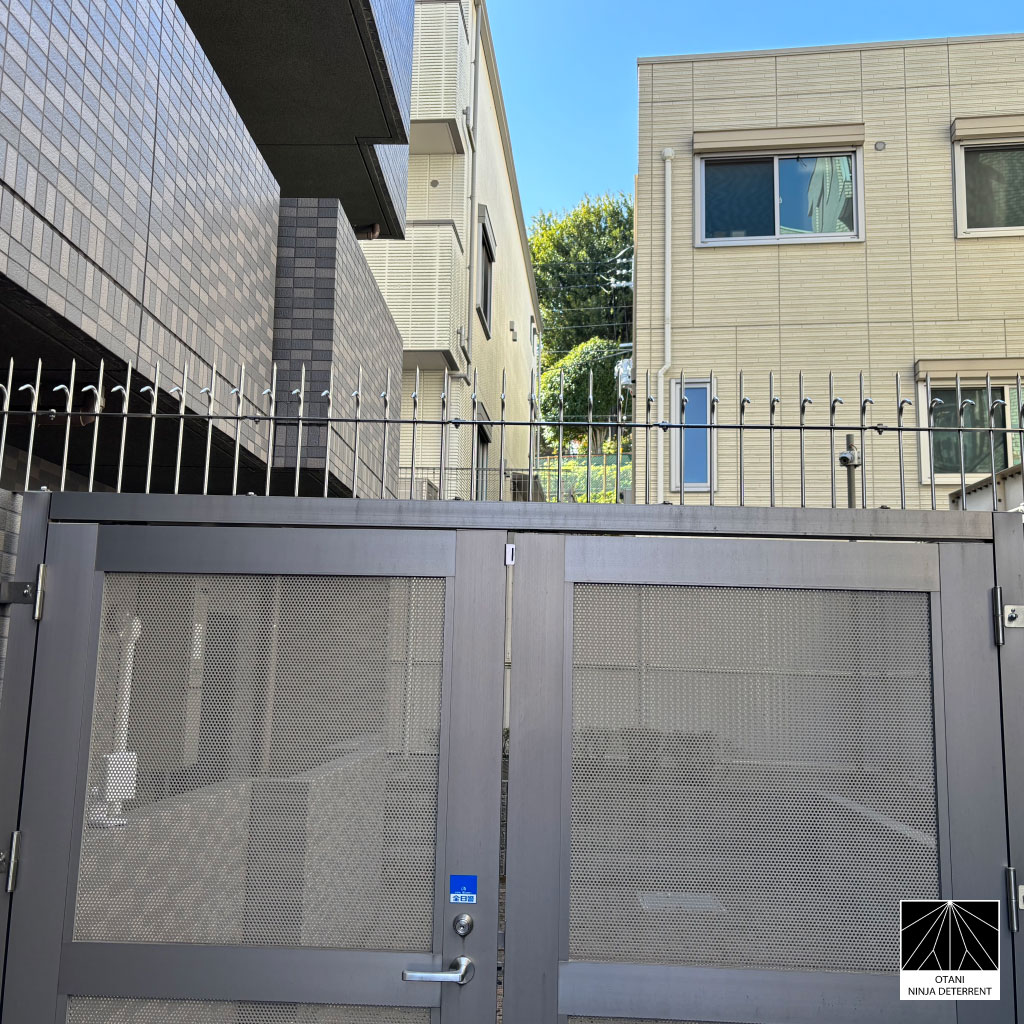 Stainless steel Ninja Deterrent™ security spikes installed on a modern metal gate – anti-climb and bird control design blending protection with architecture