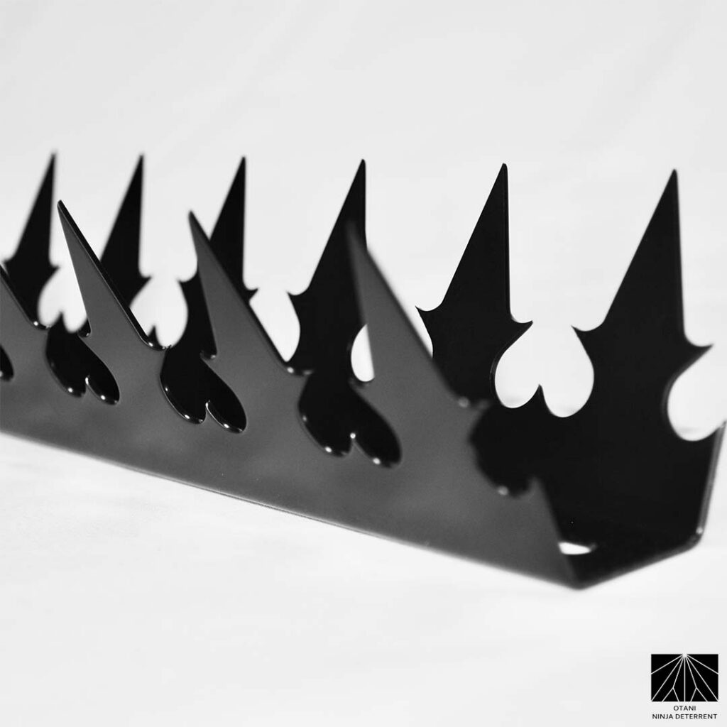 Studio close-up of GIZAGIZA black dual heart security spike with sharp triangular blades – Japanese-made minimalist perimeter ninja deterrent