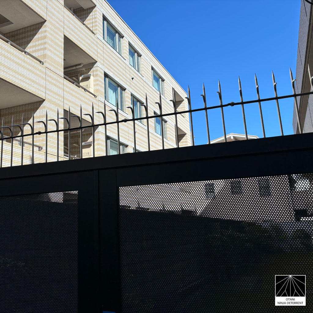 Ninja Deterrent™ anti-climb and bird control spikes installed on a modern metal fence – Japanese-made security solution combining minimal design and strong protection