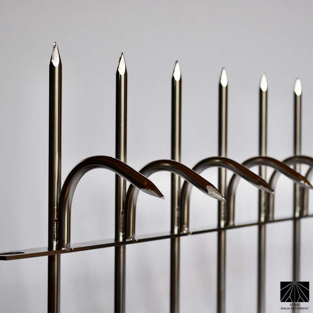 Polished stainless steel Ninja Deterrent™ security spikes with curved anti-climb hooks – Japanese-made architectural bird and intrusion deterrent for modern properties