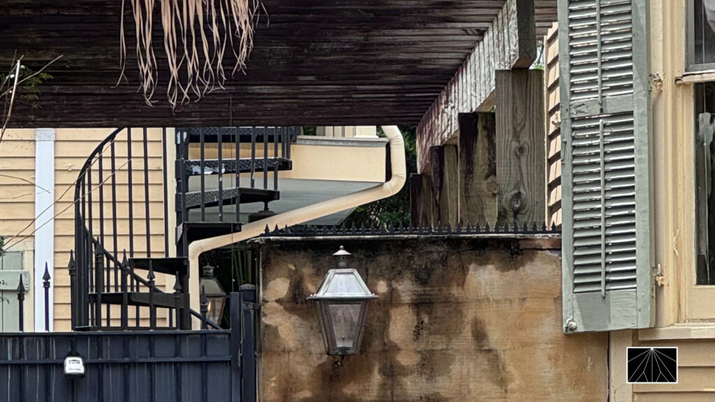 Ninja Deterrent™ anti-climb spikes installed on a historic-style gate and wall, enhancing security while preserving the charm of classic architecture.