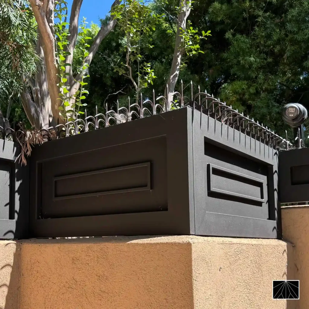 Barrera de seguridad Ninja Deterrent con pinchos decorativos negros instalada sobre un parapeto, proporcionando protección perimetral con un diseño arquitectónico elegante.