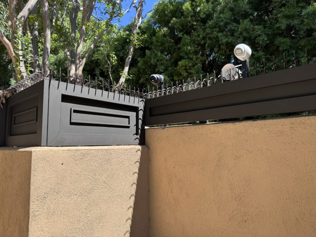 Entry perimeter fence with Classic Short Dual (Black) anti-climb spikes installed continuously along the top edge