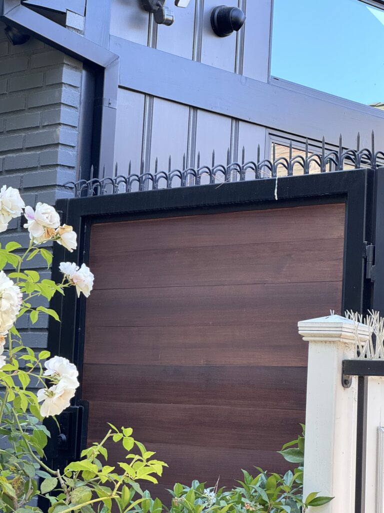 Detail of a black metal gate topline with anti-climb spikes installed, Westwood residential property.