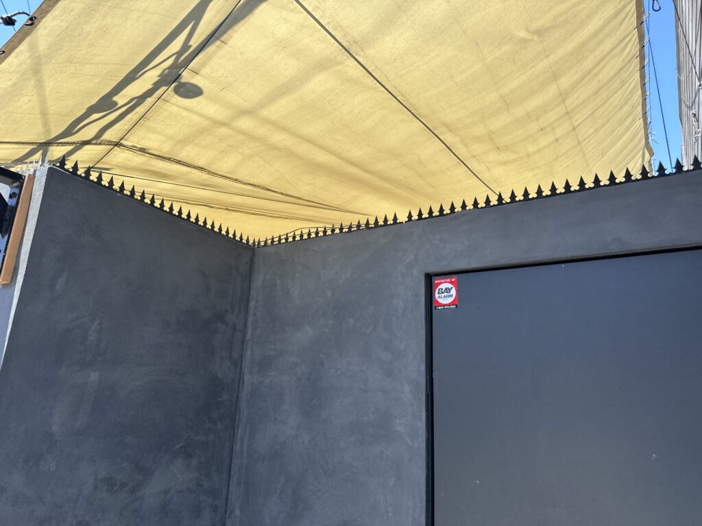 Détail d’angle montrant une couverture Gothic sans interruption sur un mur périmétrique noir.